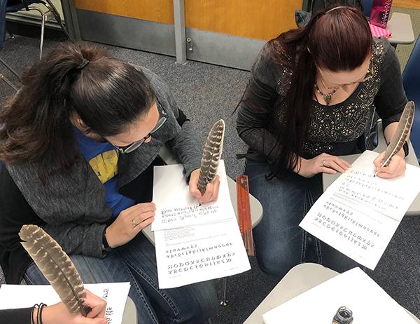 Other students using quills to write